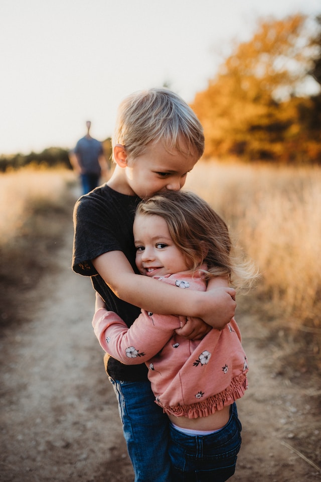 A boy hugging a girl